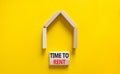 Time to rent house symbol. Concept words `Time to rent` on wooden blocks near miniature house. Beautiful yellow background, copy Royalty Free Stock Photo