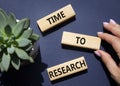 Time to Research symbol. Concept word Time to Research on wooden blocks. Businessman hand. Beautiful deep blue background. Royalty Free Stock Photo