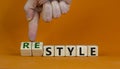 Time to restyle. Concept words `style` and `restyle` on cubes on a beautiful orange background. Male hand. Business and restyl Royalty Free Stock Photo