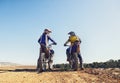 Time to rip up this track. Two motocross riders talking before a race. Royalty Free Stock Photo