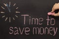 Time to save money - clock with text on black Royalty Free Stock Photo