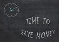 Time to Save Money - clock with text on black background Royalty Free Stock Photo