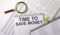 TIME TO SAVE MONEY text written on notebook on chart with keyboard and planning Royalty Free Stock Photo