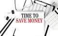 TIME TO SAVE MONEY word on notepad with clipboard , chart and calculator, business concept Royalty Free Stock Photo