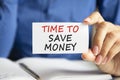 Time to save money written on a paper card in woman hand Royalty Free Stock Photo