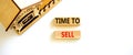 Time to sell house symbol. Concept words `Time to sell` on wooden blocks near miniature house. Beautiful white background, copy