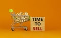 Time to sell real estate symbol. Wooden blocks, words `time to sell` on beautiful orange background. Shopping cart with miniatur Royalty Free Stock Photo