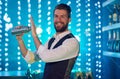 Time to shake things up in here. Portrait of a handsome young bartender mixing drinks in a nightclub. Royalty Free Stock Photo