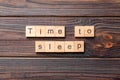 Time to sleep word written on wood block. time to sleep text on cement table for your desing, concept