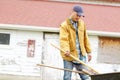 Time to start cleaning up the garden. a man taking out gardening tools from his wheelbarrow. Royalty Free Stock Photo