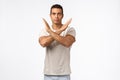 Time to stop. Serious-looking strong calm young masculine male athlete making cross with arms over chest look straight