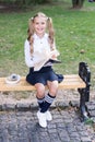 Time to study. Schoolgirl reading book. Little genius. Schoolgirl relaxing sit bench with book. Studying in school yard Royalty Free Stock Photo