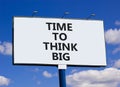Time to think big symbol. Concept words Time to think big on beautiful big white billboard. Beautiful blue sky cloud background. Royalty Free Stock Photo