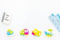 Time to travel. Accessories for treveling with children, tickets, notebook and toys on white background top view mock-up