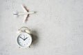 Time to travel concept. plastic plane jet toy passenger with alarm clock Royalty Free Stock Photo