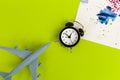 Time to travel concept. plastic plane jet toy passenger with alarm clock Royalty Free Stock Photo