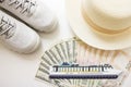 Sneakers, hat and money. American dollars and Ukrainian currency hryvnia banknotes