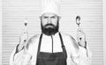 Time to try taste. Chef serious face hold spoon and fork. Man handsome with beard holds kitchenware on white background