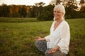 Time to unwind. Portrait of an attractive mature woman doing yoga in nature. Royalty Free Stock Photo