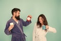 Time to wake up and have nice day. Guy husband hold coffee and clock. Every morning begins with coffee. Couple in Royalty Free Stock Photo