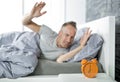 Time to wake up. Tired man in the bed Royalty Free Stock Photo