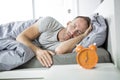 Time to wake up. Tired man in the bed Royalty Free Stock Photo