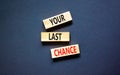 Time to your last chance symbol. Concept words Your last chance on wooden blocks on a beautiful black table black background. Royalty Free Stock Photo