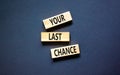 Time to your last chance symbol. Concept words Your last chance on wooden blocks on a beautiful black table black background. Royalty Free Stock Photo