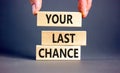 Time to your last chance symbol. Concept words Your last chance on wooden blocks on a beautiful grey table grey background. Royalty Free Stock Photo