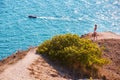 Time for trip. Lady with suitcase enjoying seascape. Yacht floating in ocean, copy space. Travel desire. Summer holiday.