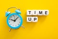 Time Up word with clock on yellow background Royalty Free Stock Photo