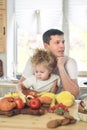 Time for vitamins. Cute little girl and her handsome dad having breakfast at the kitchen table