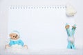 Time for winter holidays. Blank notepad, teddy bear with snowballs, toy wooden blue skis and white hat on snowy Royalty Free Stock Photo