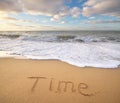 Time word on the sea sand. Royalty Free Stock Photo