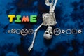 Time wording beside  cogwheels and  artificial skeleton as time concept Royalty Free Stock Photo