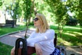 Time for yourself. Ways to give yourself break and enjoy leisure. Girl sit bench relaxing in shadow green nature