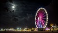 Timelapse Ferris Wheel night citscape and beach with full moon