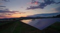 A timelapse image capturing the transition from day to night with the solar panels still hard at work and providing Royalty Free Stock Photo