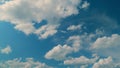 Light High Clouds Slide On Sky. Puffy Fluffy White Clouds Sky. Blue Sky With Clouds Moving In Opposite Direction And Sun Royalty Free Stock Photo