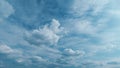 Light High Clouds Slide On Sky. Puffy Fluffy White Clouds Sky. Blue Sky With Clouds Moving In Opposite Direction And Sun Royalty Free Stock Photo