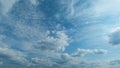 Light High Clouds Slide On Sky. Puffy Fluffy White Clouds Sky. Blue Sky With Clouds Moving In Opposite Direction And Sun Royalty Free Stock Photo