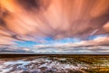 Timelapse movement of clouds across marshland