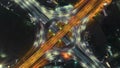 Timelapse of night city traffic on 4-way stop street intersection circle roundabout in bangkok, thailand. 4K UHD horizontal aerial