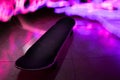 Timelapse shot of a skateboard with colorful light effects