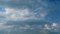 Summer skyscape with dark storm rain clouds on sky. Clouds against a blue sky turning into dark rain cyclones. Timelapse