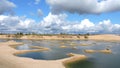 Timelapse, white clouds float over a beautiful mountain lake with sandy beaches