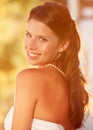 Timeless beauty. Portrait of a beautiful young bride looking over her shoulder and smiling at the camera. Royalty Free Stock Photo