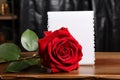 Timeless beauty Red rose on old wooden table with paper