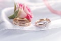 Timeless love Wedding rings on white and red roses backdrop Royalty Free Stock Photo