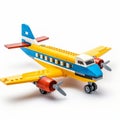 Timeless Nostalgia: Small Yellow And Blue Toy Airplane With Bold Structural Designs